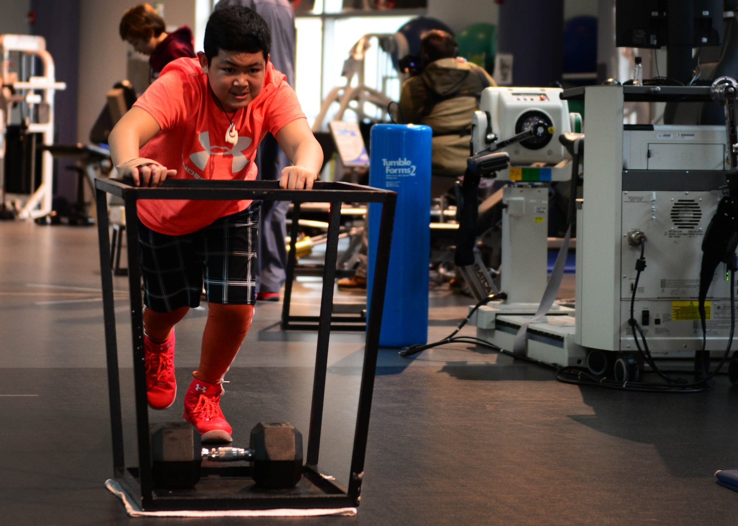 Kimo Martinez pushes a weighted sled during a rehabilitation session at the Center for Intrepid on Joint Base San Antonio-Fort Sam Houston, Texas, Dec. 7, 2016. During the Brussels Airport bombing March 22, 2016, that tragically killed his mother, Kimo and his family sustained multiple injuries that have led to extensive rehabilitative procedures. (U.S. Air Force photo by Senior Airman Chip Pons)