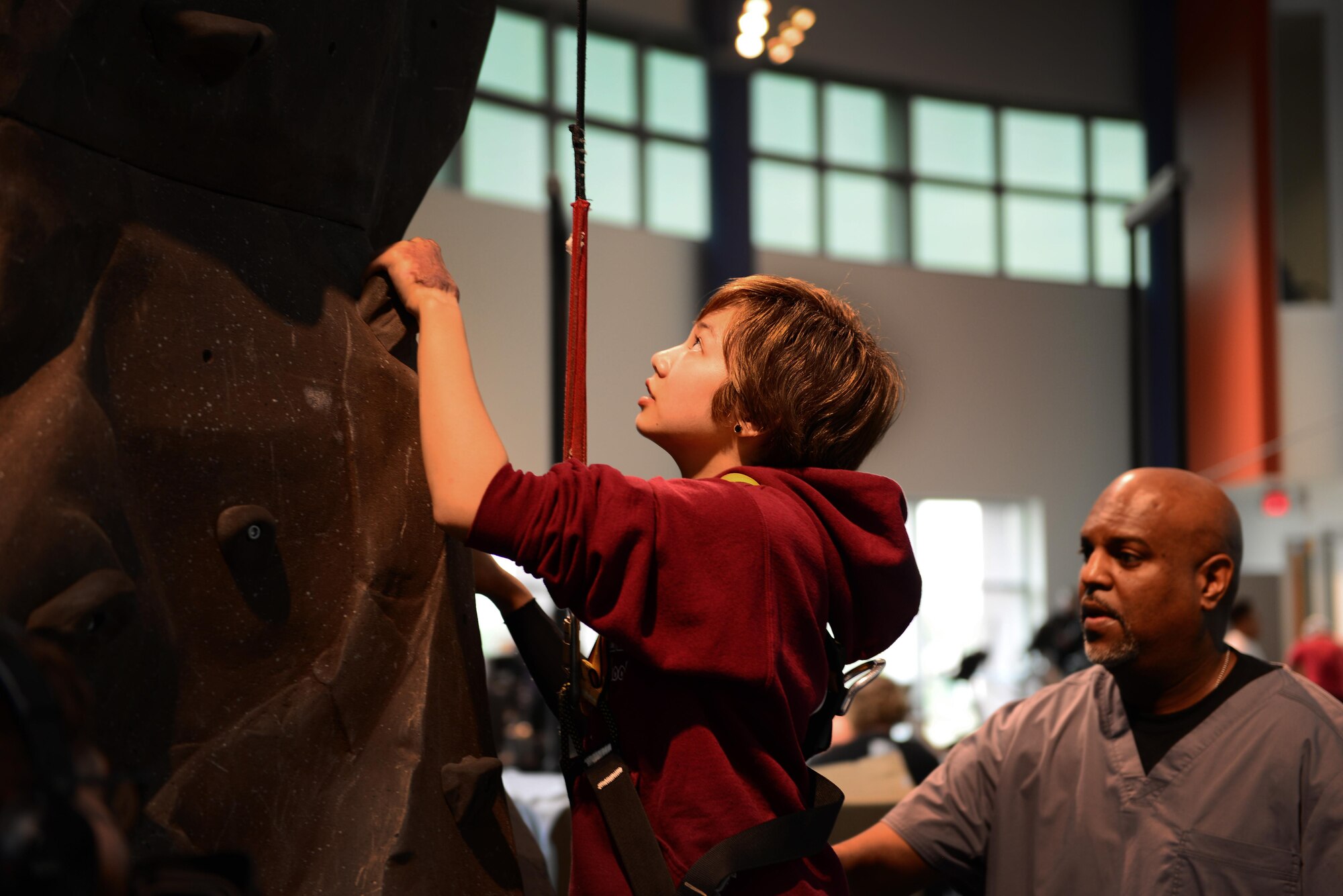 Kianni Martinez prepares to climb a rock wall during a rehabilitation session at the Center for the Intrepid at Joint Base San Antonio-Fort Sam Houston, Texas, Dec. 7, 2016. During the Brussels Airport bombing March 22, 2016 that tragically killed her mother and injured her family members, Kianni suffered multiple burns and injuries to her leg and has since undergone a number of grueling rehabilitative procedures. (U.S. Air Force photo by Senior Airman Chip Pons)