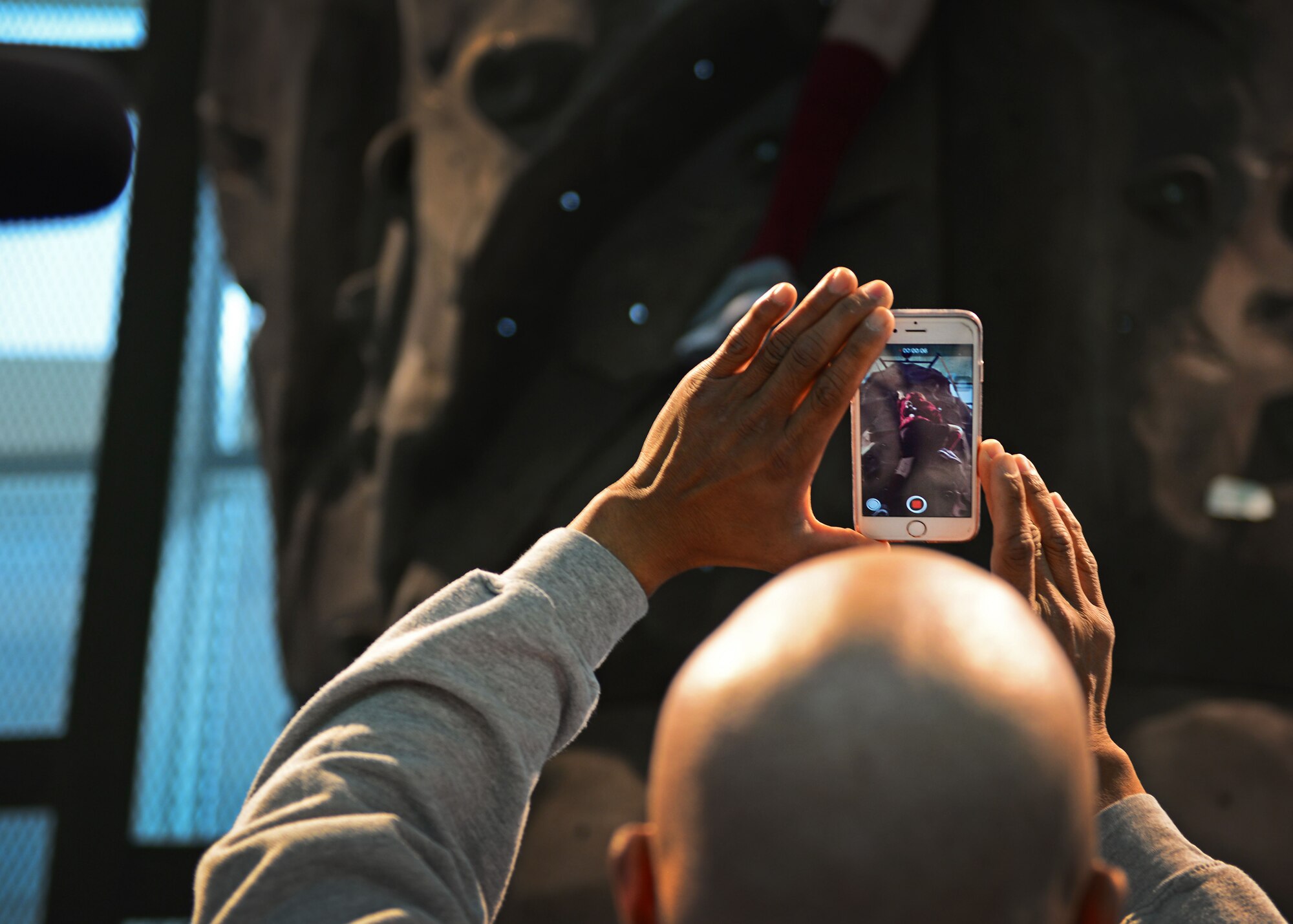 U.S. Air Force Lt. Col. Melchizedek “Kato” Martinez, a career tactical communications officer, records his daughter Kianni during a rehabilitation session at the Center for the Intrepid at Joint Base San Antonio-Fort Sam Houston, Texas, Dec. 7, 2016. During the Brussels Airport bombing March 22, 2016, which tragically killed his wife and injured his children, Kato suffered multiple burns and injuries and has since undergone a number of grueling rehabilitative procedures. (U.S. Air Force photo by Senior Airman Chip Pons