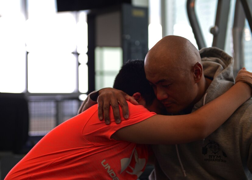 U.S. Air Force Lt. Col. Melchizedek “Kato” Martinez, a career tactical communications officer, embraces his son, Kimo, after a rehabilitation session at the Center for the Intrepid at Joint Base San Antonio-Fort Sam Houston, Texas, Dec. 7, 2016. During the Brussels Airport bombing March 22, 2016, which tragically killed his wife and injured his children, Kato suffered multiple burns and injuries and has since undergone a number of grueling rehabilitative procedures. (U.S. Air Force photo by Senior Airman Chip Pons)