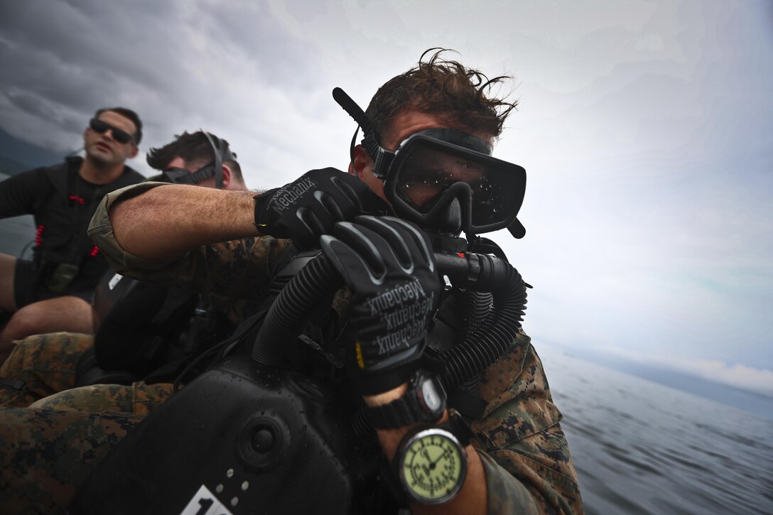 Marines with 4th Force Reconnaissance Battalion preps his scuba gear during dive operations in Kaneohe Bay, Hawaii, Dec. 9, 2016. The mission of Marine Corps Base Hawaii is to provide facilities, programs and services in direct support of units, individuals and families in order to enhance and sustain combat readiness for all operating forces and tenant organizations aboard MCB Hawaii. (U.S. Marine Corps photo by Cpl. Aaron S. Patterson/Released)