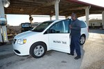 Donald Cruz, 502nd Logistics Readiness Squadron vehicle operator, inspects his taxi Dec. 6 at Joint Base San Antonio-Randolph. When members at Joint Base San Antonio locations need a ride for work-related functions, they call on the 502nd Logistics Readiness Squadron military taxi to help them get to their destination.