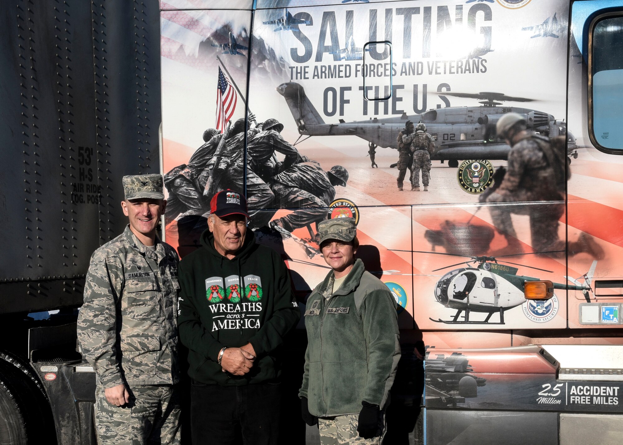 Col. Ryan Samuelson, 92nd Air refueling Wing commander, Fred Fossett, volunteer truck driver, and Chief Master Sgt. Shannon Rix, 92nd ARW command chief, stand next to Fossett’s semitrailer Dec. 13, 2016, at Fairchild Air Force Base, Wash. For the last two years Fossett, a veteran himself, has delivered hundreds of wreaths to Fairchild for Wreaths Across America events. These events take place all over the country on the second weekend in December, where wreaths are laid on head stones at Veteran Cemeteries. (U.S. Air Force photo/Airman 1st Class Taylor Shelton)