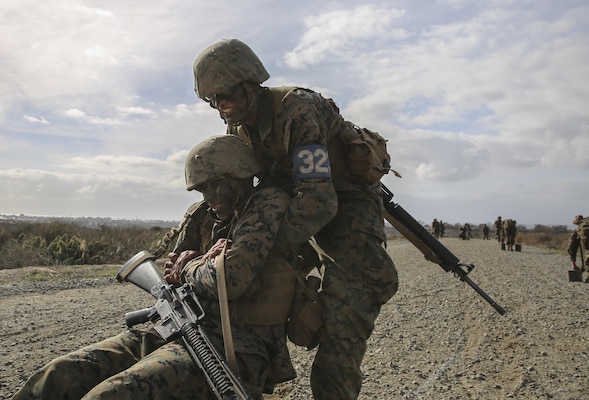 Private First Class Justin P. Rainey, Kilo Company, 3rd Recruit Training Battalion, carries a fellow recruit during the Crucible at Marine Corps Base Camp Pendleton, Calif., Dec. 5. Following recruit training, Rainey will report to the School of Infantry at Marine Corps Base Camp Pendleton, Calif., and then the Infantry Training Battalion to become an infantryman. Annually, more than 17,000 males recruited from the Western Recruiting Region are trained at MCRD San Diego.