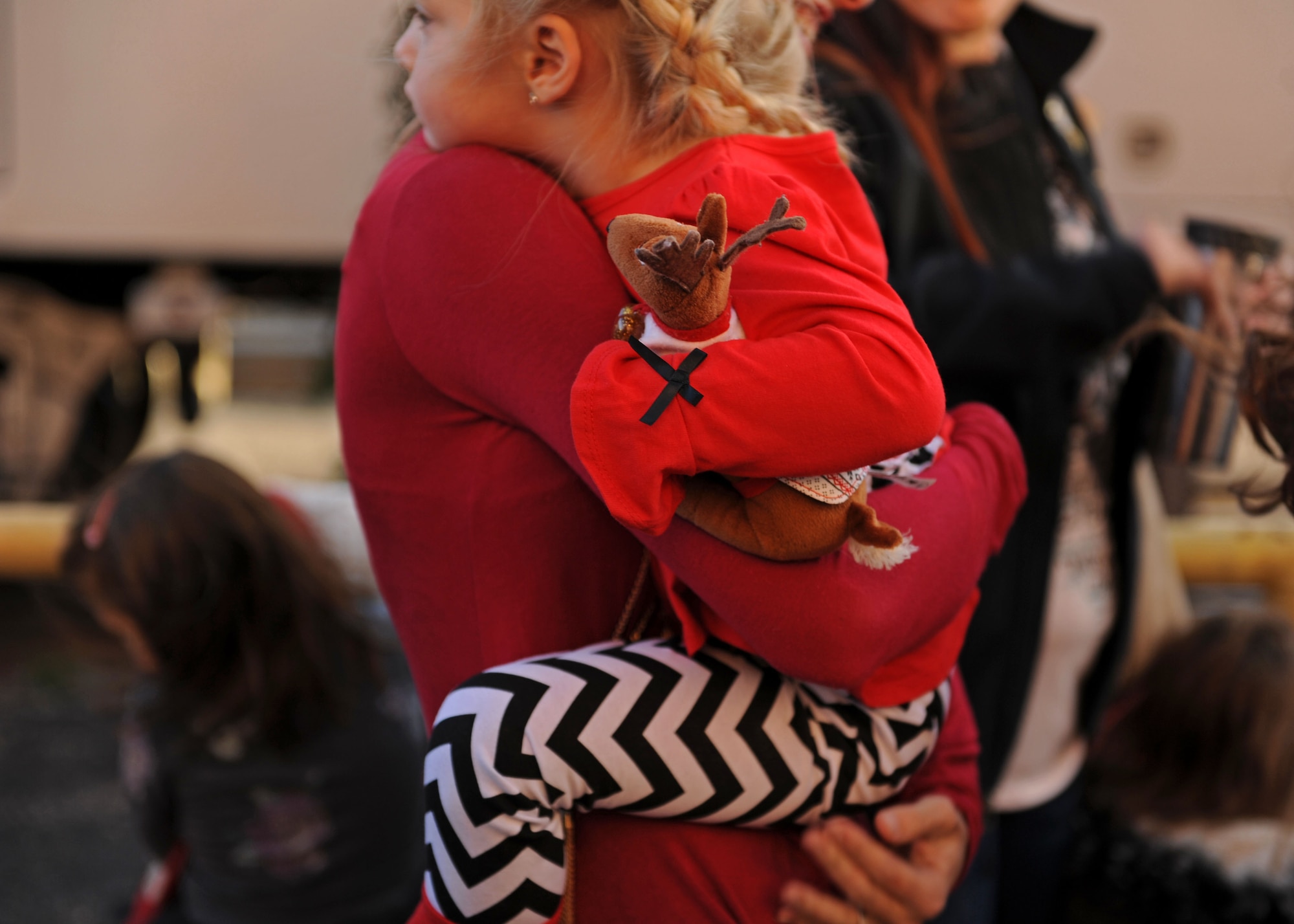 A mother and daughter from Cannon Air Force Base, N.M., wait to board the Holiday Express, Dec. 1, 2016, at a railyard in downtown Clovis, N.M. For nine consecutive years, the BNSF Railway has invited service members and their loved ones aboard the Holiday Express to enjoy milk, cookies, and a visit from Santa Claus to show their appreciation. (U.S. Air Force photo by Staff Sgt. Whitney Amstutz/Released)