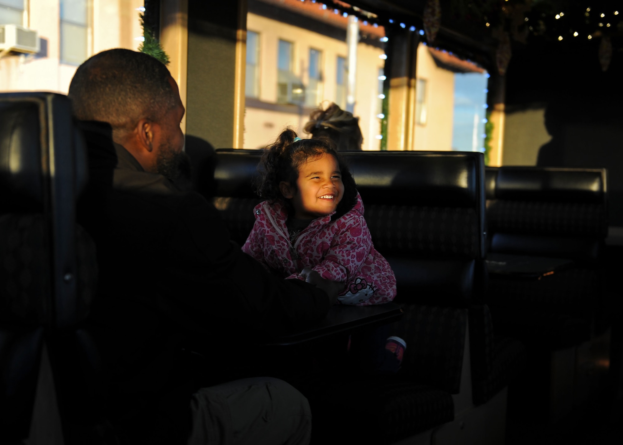 A dependent from Cannon Air Force Base, N.M., smiles aboard the Holiday Express, Dec. 1, 2016, in Clovis, N.M. For nine consecutive years, the BNSF Railway has invited service members and their loved ones aboard the Holiday Express to enjoy milk, cookies, and a visit from Santa Claus to show their appreciation. (U.S. Air Force photo by Staff Sgt. Whitney Amstutz/Released)  