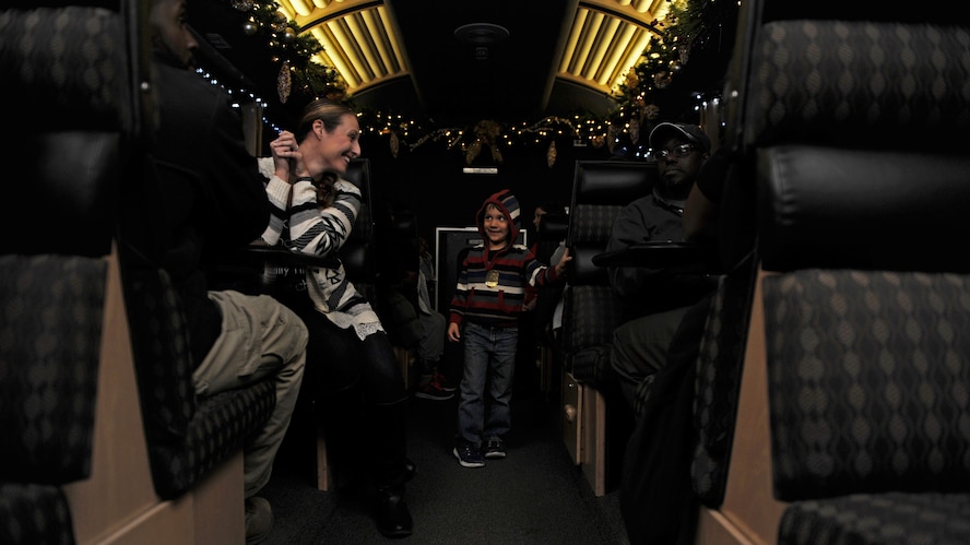 A dependent from Cannon Air Force Base, N.M., greets fellow passengers aboard the Holiday Express, Dec. 1, 2016, in Clovis, N.M. For nine consecutive years, the BNSF Railway has invited service members and their loved ones aboard the Holiday Express to enjoy milk, cookies, and a visit from Santa Claus to show their appreciation. (U.S. Air Force photo by Staff Sgt. Whitney Amstutz/Released)