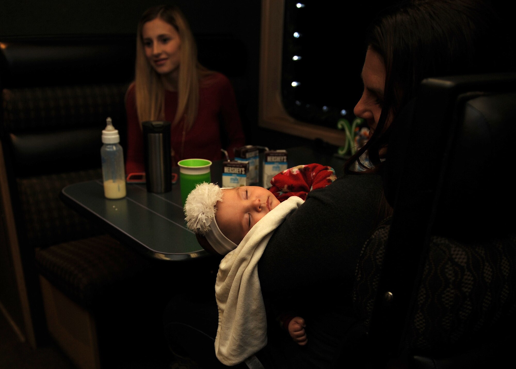 A dependent from Cannon Air Force Base, N.M., takes a nap aboard the Holiday Express, Dec. 1, 2016, in Clovis, N.M. For nine consecutive years, the BNSF Railway has invited service members and their loved ones aboard the Holiday Express to enjoy milk, cookies, and a visit from Santa Claus to show their appreciation. (U.S. Air Force photo by Staff Sgt. Whitney Amstutz/Released)
