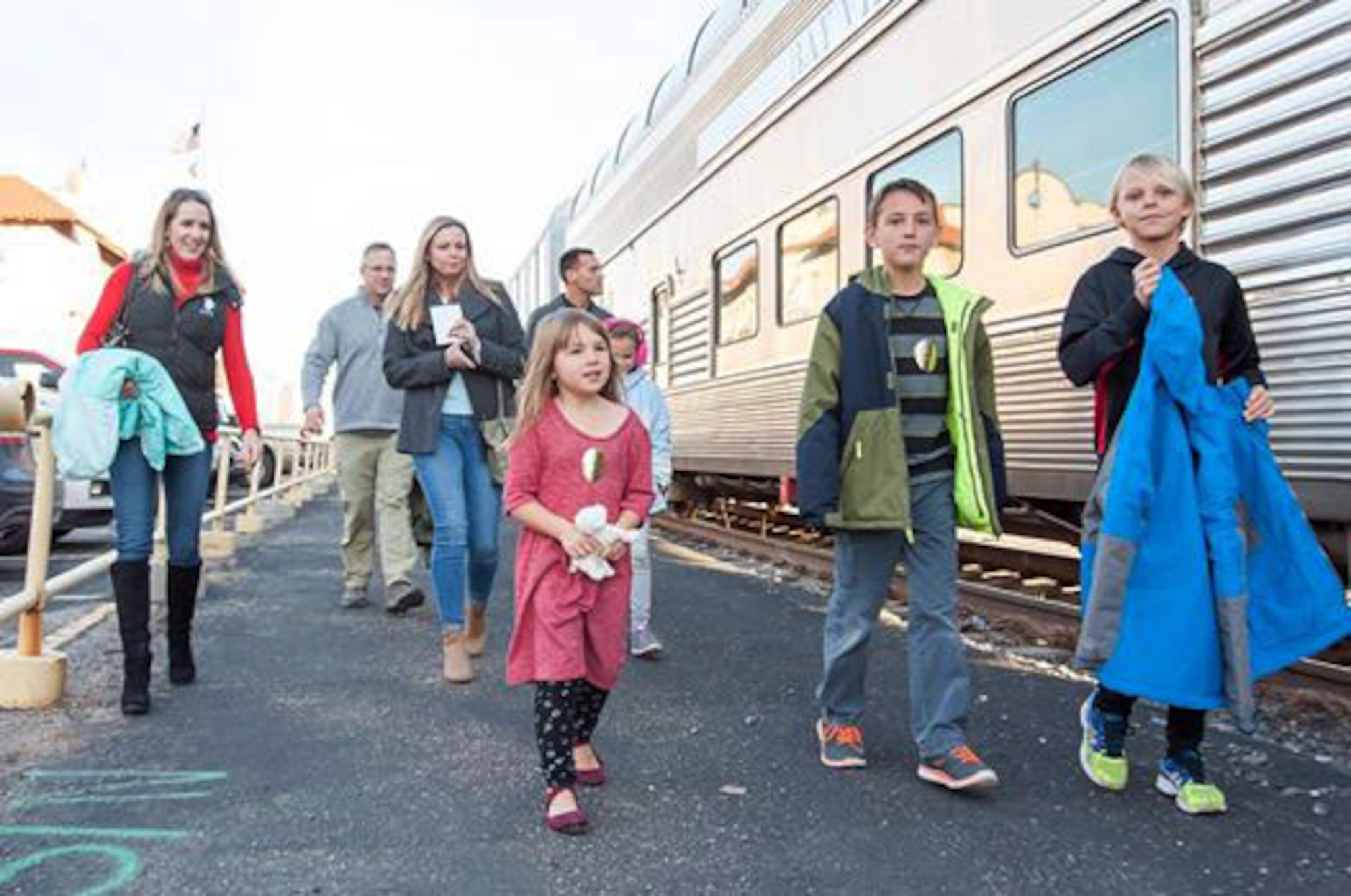 Air Commandos and family members from Cannon Air Force Base, N.M., prepare to board the Holiday Express, Dec. 1, 2016, at a railyard in downtown Clovis, N.M. For nine consecutive years, the BNSF Railway has invited service members and their loved ones aboard the Holiday Express to enjoy milk, cookies, and a visit from Santa Claus to show their appreciation. (U.S. Air Force Courtesy Photo)  