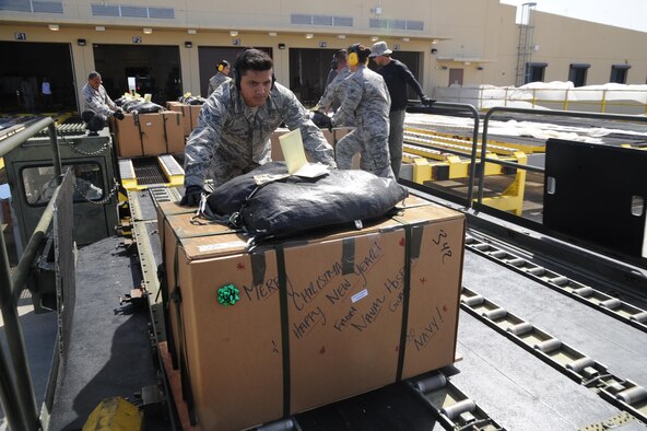 U.S. Air Force Senior Airman Paul Ibanez, an  air transportation specialists with the Air Force Reserve's 44th Aerial Port Squadron, pushes a Christmas box on to the back of a 60K loader as a part of the 65th Operation Christmas Drop, at Andersen Air Force Base, Guam, Dec. 7, 2016. Operation Christmas Drop is the longest running humanitarian airlift operation in the history of the Department of Defense, impacting the lives of more than 20,000 islanders. The people of the Micronesian islands can expect to see service members aboard a C-130 Hercules drop a box, attached to a parachute, filled with rice, fish hooks, educational materials, clothing and toys. The 44th Aerial Port Squadron supports the 624th Regional Support Group's mission to deliver mission essential capability through combat readiness, quality management and peacetime deployments in the Pacific area of responsibility. (U.S. Air Force photo by Master Sgt. Theanne Herrmann)