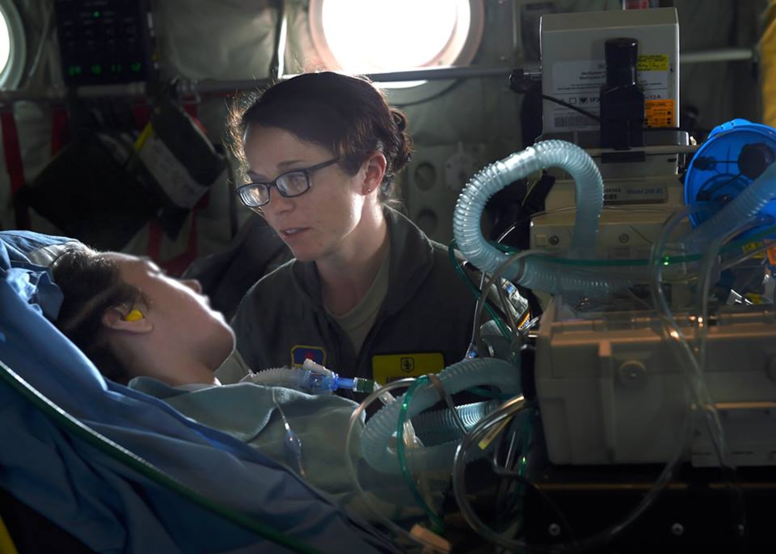 2nd Lt. Andrea Perez, member of the 59th Medical Wing Acute Lung Rescue Transport team, monitor a patient onboard a C-130J Super Hercules, Dec. 12, 2016. The 59th Medical Wing’s Acute Lung Rescue Team provided medical care for a military dependent, during the four-hour flight.. (U.S. Air Force photo/Staff Sgt. Jason Huddleston)