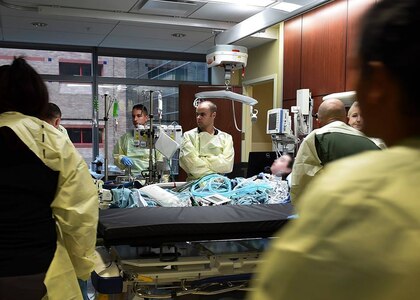 The 59th Medical Wing Acute Lung Rescue Transport team prepares to transport a patient to the University of California, Los Angeles Medical Center at the San Antonio Military Medical Center on Joint Base San Antonio-Fort Sam Houston, Texas, Dec. 12, 2016. The 59th Medical Wing’s Acute Lung Rescue Team provided medical care for a military dependent, during the four-hour flight.. (U.S. Air Force photo/Staff Sgt. Jerilyn Quintanilla)
