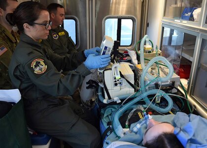 2nd Lt. Andrea Perez, member of the 59th Medical Wing Acute Lung Rescue Transport team, tends to a patient while onboard an ambulance on Kelly Field Annex, San Antonio, Dec. 12, 2016. A unique 59th Medical Wing capability, the ECMO transport program began at Wilford Hall Medical Center in the 1990s. (U.S. Air Force photo/Staff Sgt. Jerilyn Quintanilla)