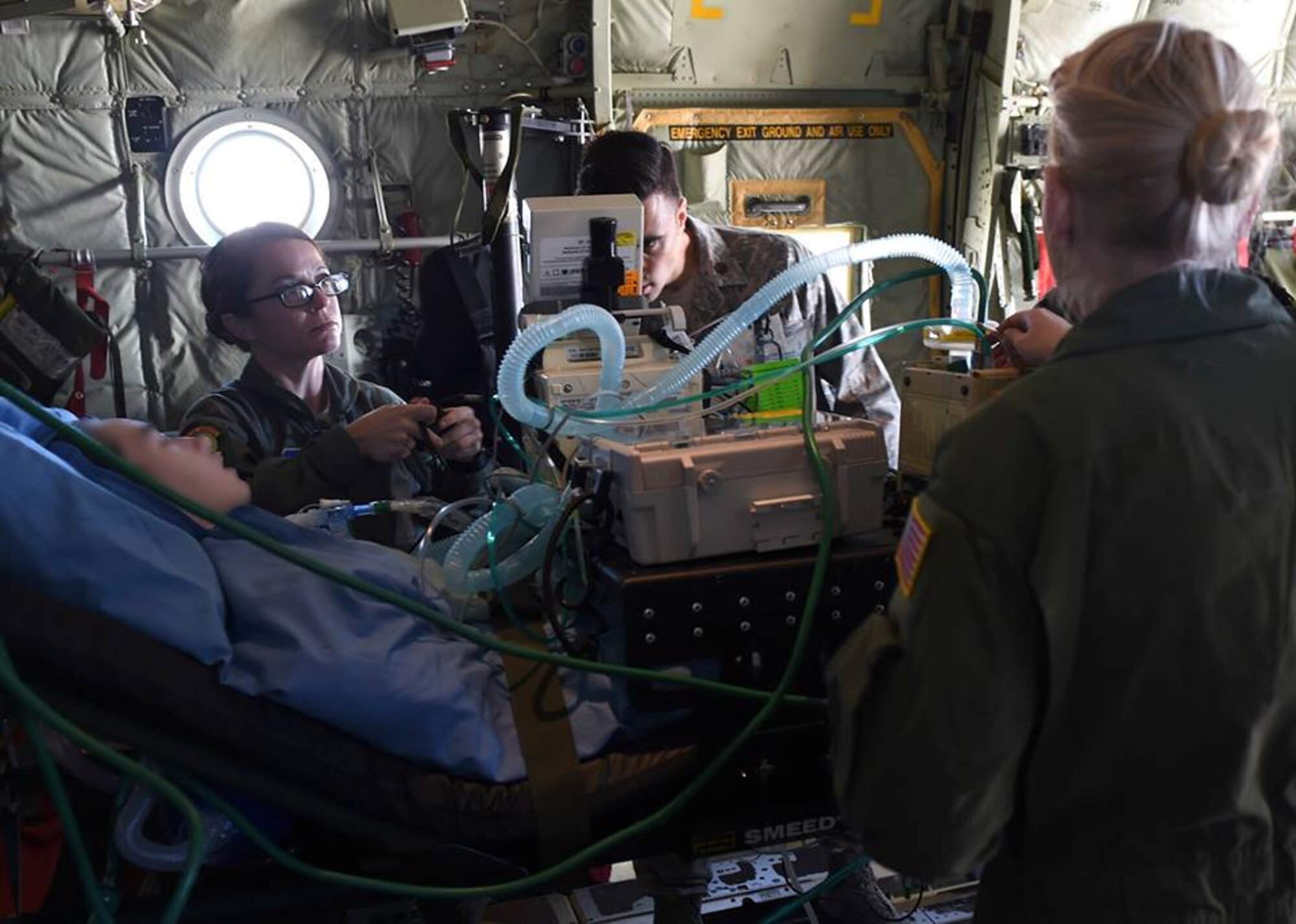 2nd Lt. Andrea Perez, Maj. Jeffrey DellaVolpe, and Staff Sgt. Cynthia Thurman, members of the 59th Medical Wing Acute Lung Rescue Transport team, tends to a patient while onboard an ambulance on Kelly Field Annex, San Antonio, Dec. 12, 2016. A unique 59th Medical Wing capability, the ECMO transport program began at Wilford Hall Medical Center in the 1990s. (U.S. Air Force photo/Staff Sgt. Jason Huddleston)
