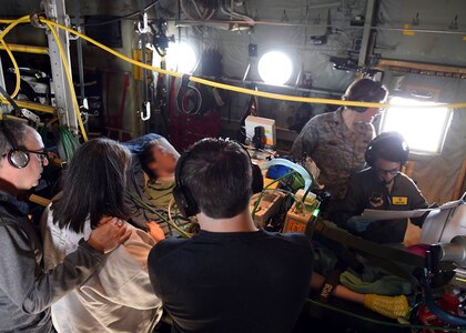 Members of the 59th Medical Wing Acute Lung Rescue Transport team monitor a patient onboard a C-130J Super Hercules, Dec. 12, 2016. A unique 59th Medical Wing capability, the ECMO transport program began at Wilford Hall Medical Center in the 1990s. (U.S. Air Force photo/Staff Sgt. Jason Huddleston)