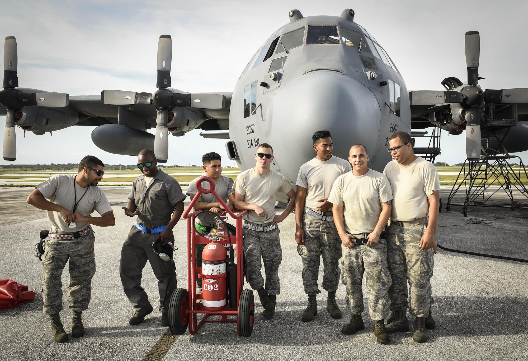 Members of the 374th Maintenance Group stand in front of a C-130H Hercules assigned to the 36th Airlift Squadron during Operation Christmas Drop 2016 at Andersen Air Force Base, Dec. 7, 2015. During OCD, the 374 MXG team kept Yokota Air Base’s C-130H Hercules flying daily so that they could deliver bundles of donated goods to the Micronesian Islands for training and Christmas celebration. (U.S. Air Force photo by Senior Airman Elizabeth Baker/Released)