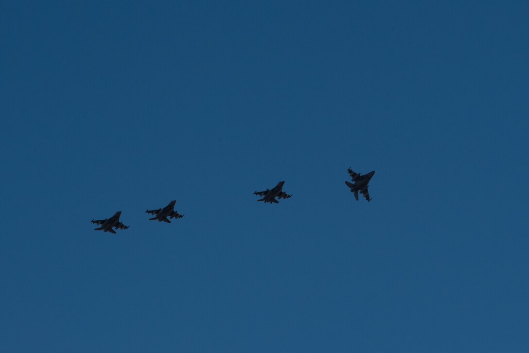 F-16 Fighting Falcons assigned to the 134th Expeditionary Fighter Squadron arrive in a four-ship formation at the 407th Air Expeditionary Group, Southwest Asia, Dec. 10, 2016. The F-16 squadron is comprised of Airmen from the 158th Fighter Wing of the Vermont Air National Guard. (U.S. Air Force photo by Master Sgt. Benjamin Wilson)(Released)