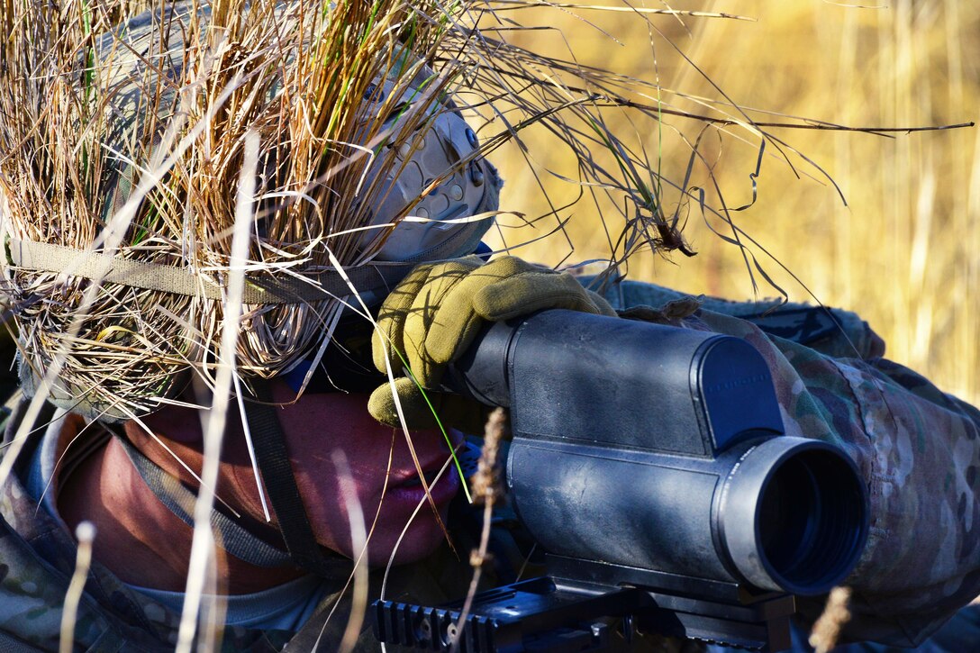 A soldier uses a spotter scope to observe targets during a live-fire exercise, part of Exercise Mountain Shock at Pocek Range in Slovenia, Dec. 8, 2016. Army photo by Paolo Bovo