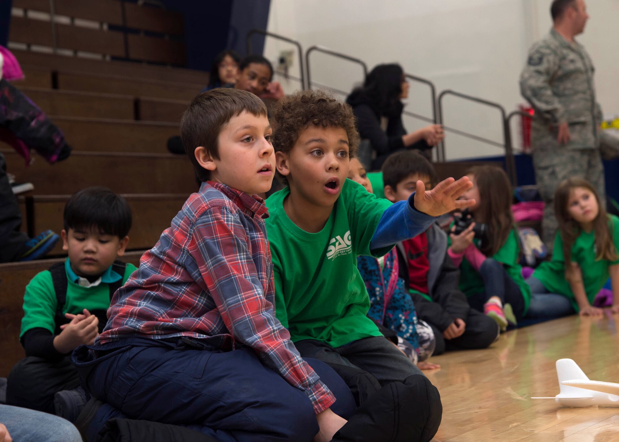 Misawa teen center children watch a drone demonstration during a safety symposium at Misawa Air Base, Japan, Dec. 8, 2016. During the symposium, children learned about the safety precautions when flying drones, how the military uses drones for missions and received a chance to fly a drone. (U.S. Air Force photo by Senior Airman Deana Heitzman)