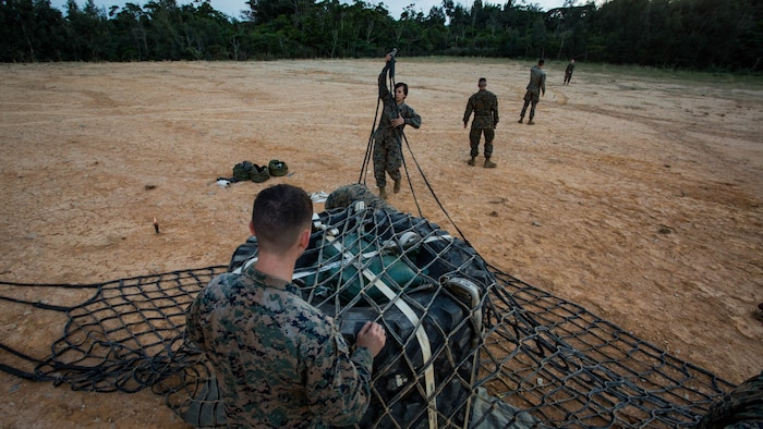 Marines assigned to Landing Support Platoon, Combat Logistics Battalion 31, 31st Marine Expeditionary Unit, set up a landing zone with a load of tires and sandbags as part of external lift operations training at Landing Zone Falcon, Okinawa, Japan, Dec. 8, 2016. CLB-31 conducted the training with Marine Medium Tiltrotor Squadron 262 (Reinforced) to complete qualifications for the 31st MEU's upcoming spring deployment. As the Marine Corps' only continuously forward-deployed unit, the MEU’s air-ground-logistics team provides a flexible force, ready to perform a wide range of military operations, from limited combat to humanitarian assistance operations, throughout the Indo-Asia-Pacific region. 