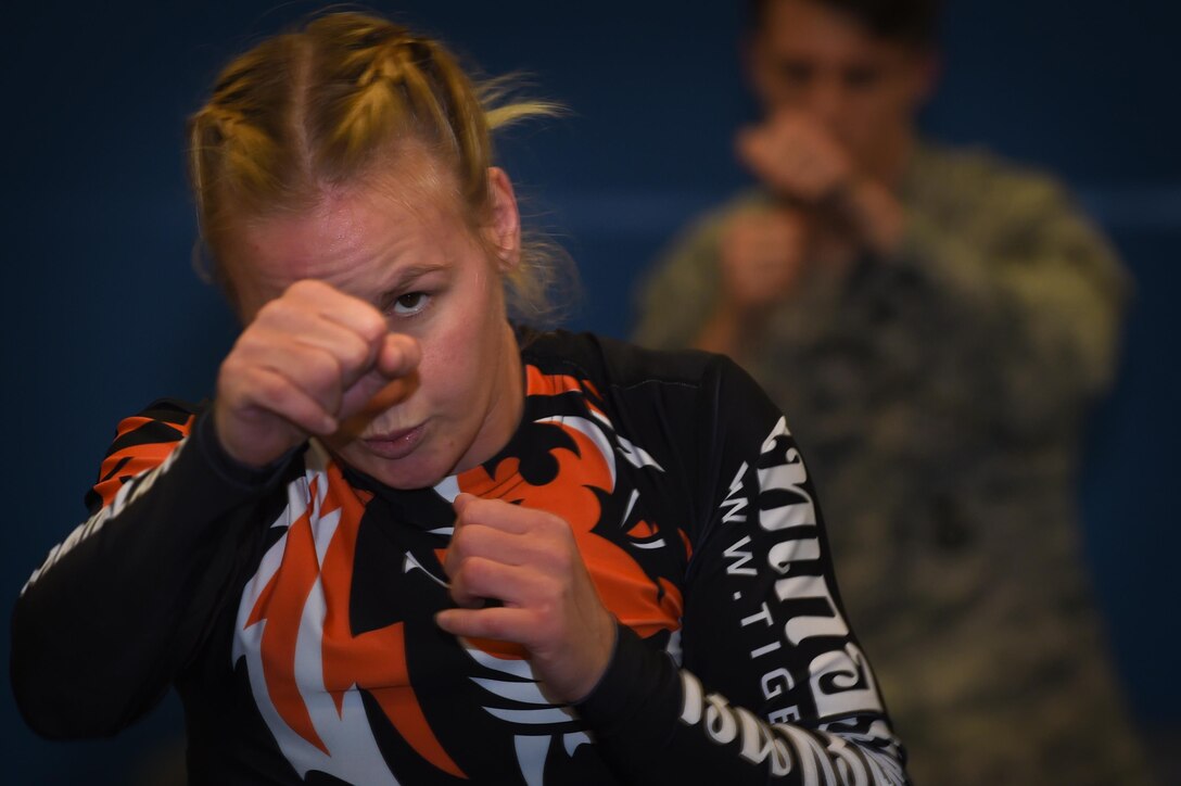 Valentina Shevchenko, UFC Bantamweight fighter, warms up with U.S. Air Force Airmen before training at Joint Base Langley-Eustis, Va., Dec. 8, 2016. Airmen and Soldiers from the installation volunteered to train with Shevchenko during the UFC morale visit to help her prepare for an upcoming fight. (U.S. Air Force photo by Staff Sgt. Natasha Stannard)