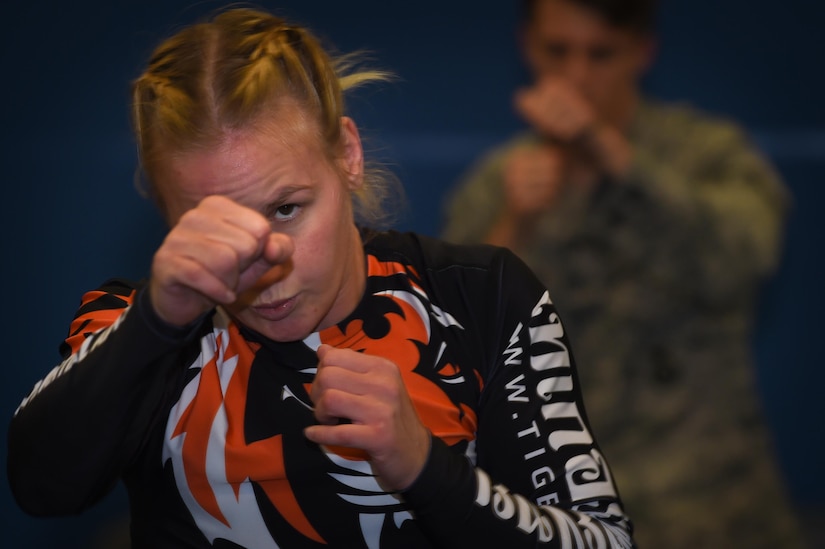 Valentina Shevchenko, UFC Bantamweight fighter, warms up with U.S. Air Force Airmen before training at Joint Base Langley-Eustis, Va., Dec. 8, 2016. Airmen and Soldiers from the installation volunteered to train with Shevchenko during the UFC morale visit to help her prepare for an upcoming fight. (U.S. Air Force photo by Staff Sgt. Natasha Stannard)