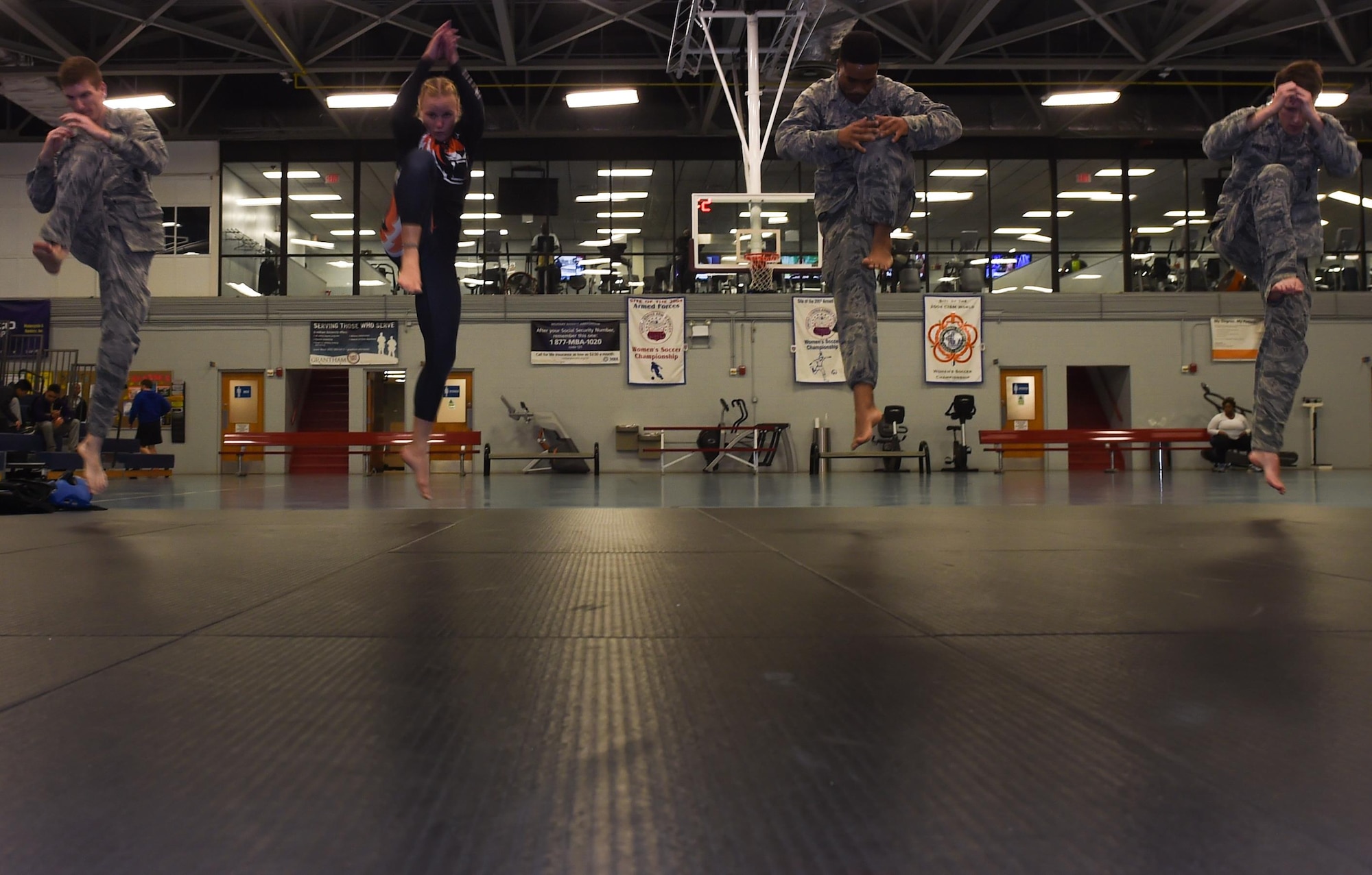 Valentina Shevchenko, UFC Bantamweight fighter, warms up with U.S. Air Force Airmen before training at Joint Base Langley-Eustis, Va., Dec. 8, 2016. Shevchenko trained with Airmen and Soldiers between touring the installation throughout the week. (U.S. Air Force photo by Staff Sgt. Natasha Stannard)