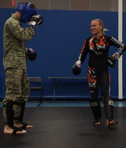 U.S. Air Force Airmen work out with Valentina Shevchenko, UFC Bantamweight fighter, at Joint Base Langley-Eustis, Va., Dec. 8, 2016. Schevchenko toured the installation along with fellow fighters Ben Rothwell and Lorenz Larkin and MAA radio hosts. (U.S. Air Force photo by Staff Sgt. Natasha Stannard)