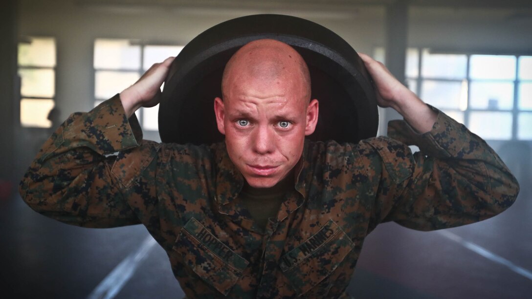 Sgt. Neil S. Hopper, a field wireman with 1st Battalion, 3rd Marine Regiment, assigned to Martial Arts Instructor Course Class 1-17, School of Infantry West, Detachment Hawaii, conducts weighted squats during the MAIC at building 222, at Marine Corps Base Hawaii, Dec. 13, 2016. The MAIC is a three week long course that puts applicants through rigorous training designed to instill teamwork and develop leadership abilities necessary for a Marine Corps Martial Arts Program instructor to teach classes. 