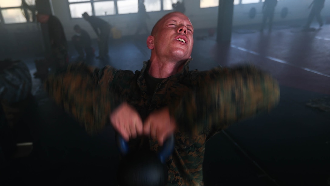 Sgt. Neil S. Hopper, a field wireman with 1st Battalion, 3rd Marine Regiment, assigned to Martial Arts Instructor Course Class 1-17, School of Infantry West, Detachment Hawaii, conducts kettle bell swings during the MAIC at building 222, at Marine Corps Base Hawaii, Dec. 13, 2016. The MAIC is a three week long course that puts applicants through rigorous training designed to instill teamwork and develop leadership abilities necessary for a Marine Corps Martial Arts Program instructor to teach classes.