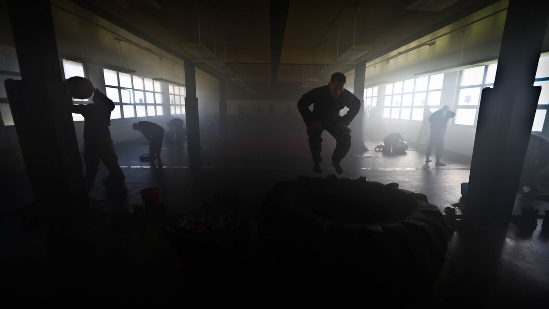 Marines assigned to Martial Arts Instructor Course (MAIC) Class 1-17, School of Infantry West, Detachment Hawaii, conduct physical training during the MAIC at building 222, at Marine Corps Base Hawaii, Dec. 13, 2016. The MAIC is a three week long course that puts applicants through rigorous training designed to instill teamwork and develop leadership abilities necessary for a Marine Corps Martial Arts Program instructor to teach classes. 