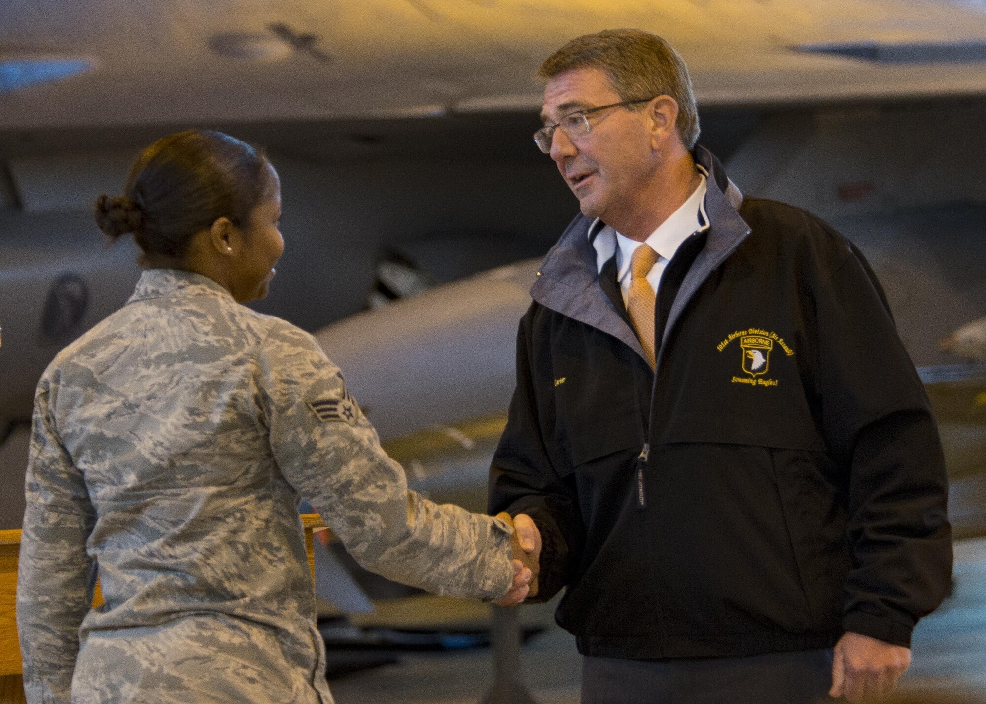 Secretary of Defense Ash Carter coins an Airman during a visit to Aviano Air Base, Italy on Dec. 13, 2016. Carter visited Team Aviano during his holiday tour to Department of Defense installations around the world. (U.S. Air Force photo by Senior Airman Cory W. Bush)