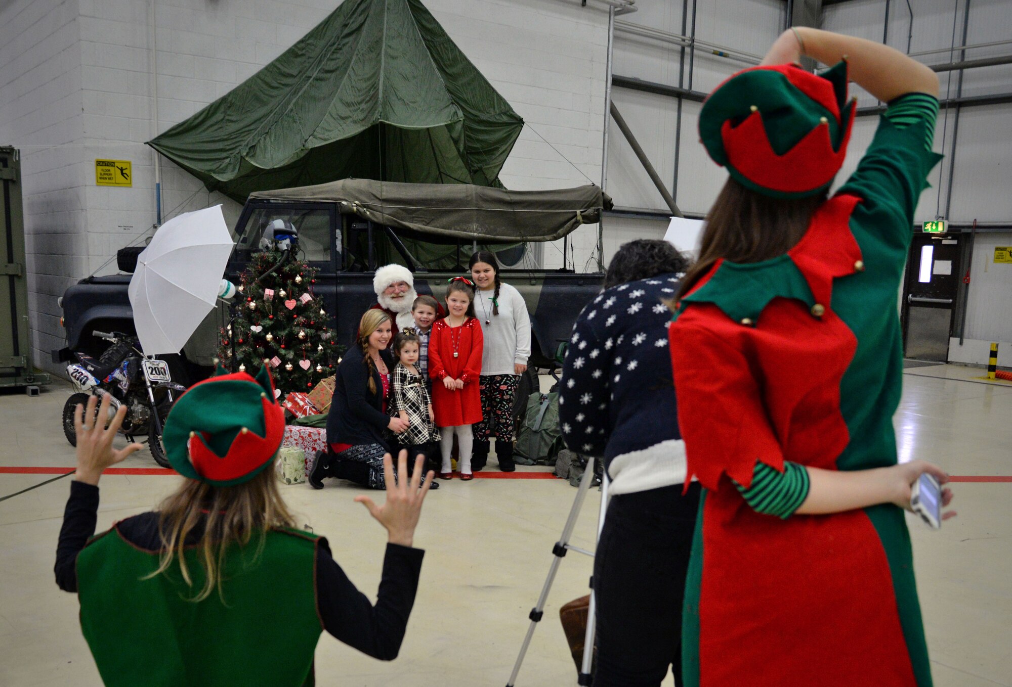 Team Mildenhall families take photographs with Santa during the annual Children’s Holiday Party Dec. 10, 2016, on RAF Mildenhall, England. This year’s Hearts Apart and Children’s Holiday party was hosted by the Military Spouses Club. (U.S. Air Force photo by Senior Airman Christine Halan) 