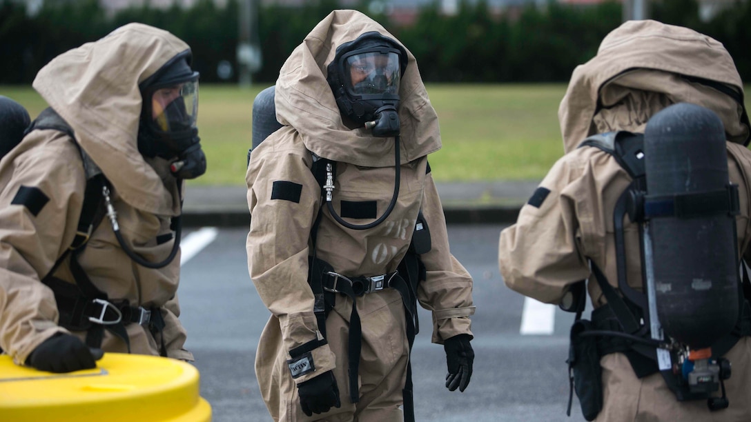 U.S. Marines with Chemical, Biological, Radiological and Nuclear Response Element from Headquarters Battalion, 3rd Marine Division, III Marine Expeditionary Force discuss a plan at a decontamination zone following a simulated chemical spill on Camp McTureous, Okinawa, Japan, Dec. 13, 2016, as a part of exercise Constant Vigilance. Constant Vigilance is an annual Marine Corps Installations Pacific exercise designed to validate and refine incident response procedures and train personnel on actions required in the event of a natural disaster. 