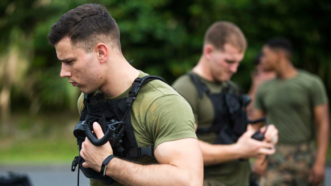 U.S. Marine Corps Cpl. Josh Hatfield a Chemical Biological Radiological Nuclear Defense Specialist with Headquarters Battalion, 3rd Marine Division, III Marine Expeditionary Force puts on his gear on Camp McTureous, Okinawa, Japan, Dec. 13, 2016, as a part of exercise Constant Vigilance. Constant Vigilance is an annual Marine Corps Installations Pacific exercise designed to validate and refine incident response procedures and train personnel on actions required in the event of a natural disaster. 