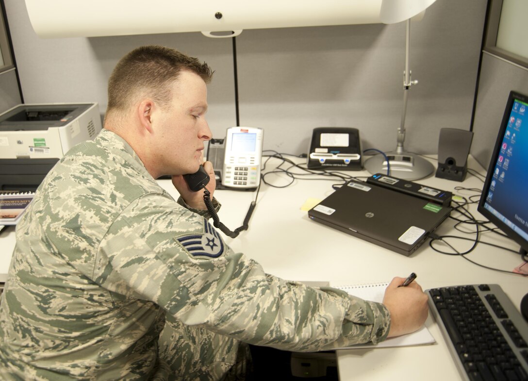 Staff Sgt. Mitchell Smith, Equal Opportunity specialist, takes a phone call during his shift at the 11th Wing Equal Opportunity Office at Joint Base Andrews, Md., December 13, 2016. Like all EO Airmen, Mitchell completed 11 weeks of technical school at the DoD Equal Opportunity Management Institute located at Patrick Air Force Base, Fla. (U.S. Air Force photo by Staff Sgt. Joe Yanik)