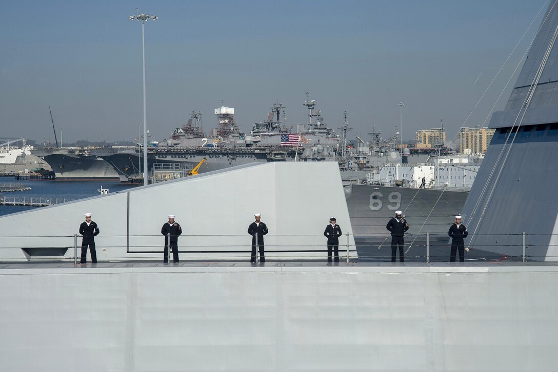 Sailors man the rail of the USS Zumwalt as it steams through San Diego Bay en route to its new homeport in San Diego, Dec. 8, 2016. Navy photo by Petty Officer 2nd Class Zachary Bell