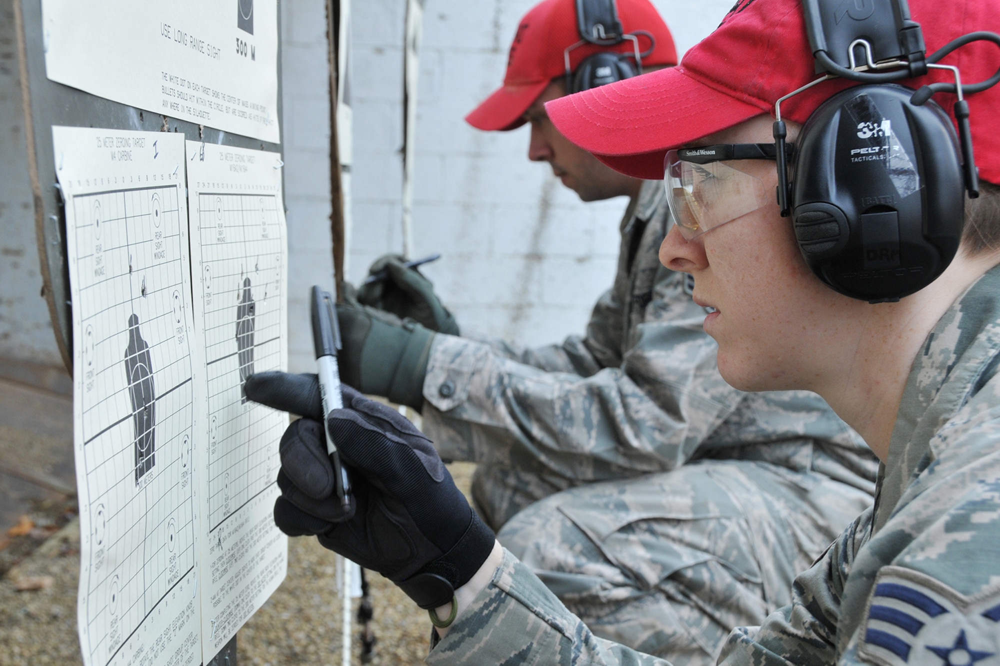 Senior Airman Danielle Massengill, a Combat Arms Instructor with the 910th Security Forces Squadron, reviews her hits on a target at the range here after firing an M-4 carbine, Dec. 3, 2016. The 910th’s Combat Arms Instructors schedule this training during less busy times of year to current on their qualifications to be able to teach others who need training on the weapon. The M-4 carbine is a shorter and lighter variant of the M16A2 assault rifle and is the primary long weapon for Air Force personnel deployed to combat areas. (U.S. Air Force photo/Staff. Sgt. Rachel Kocin)