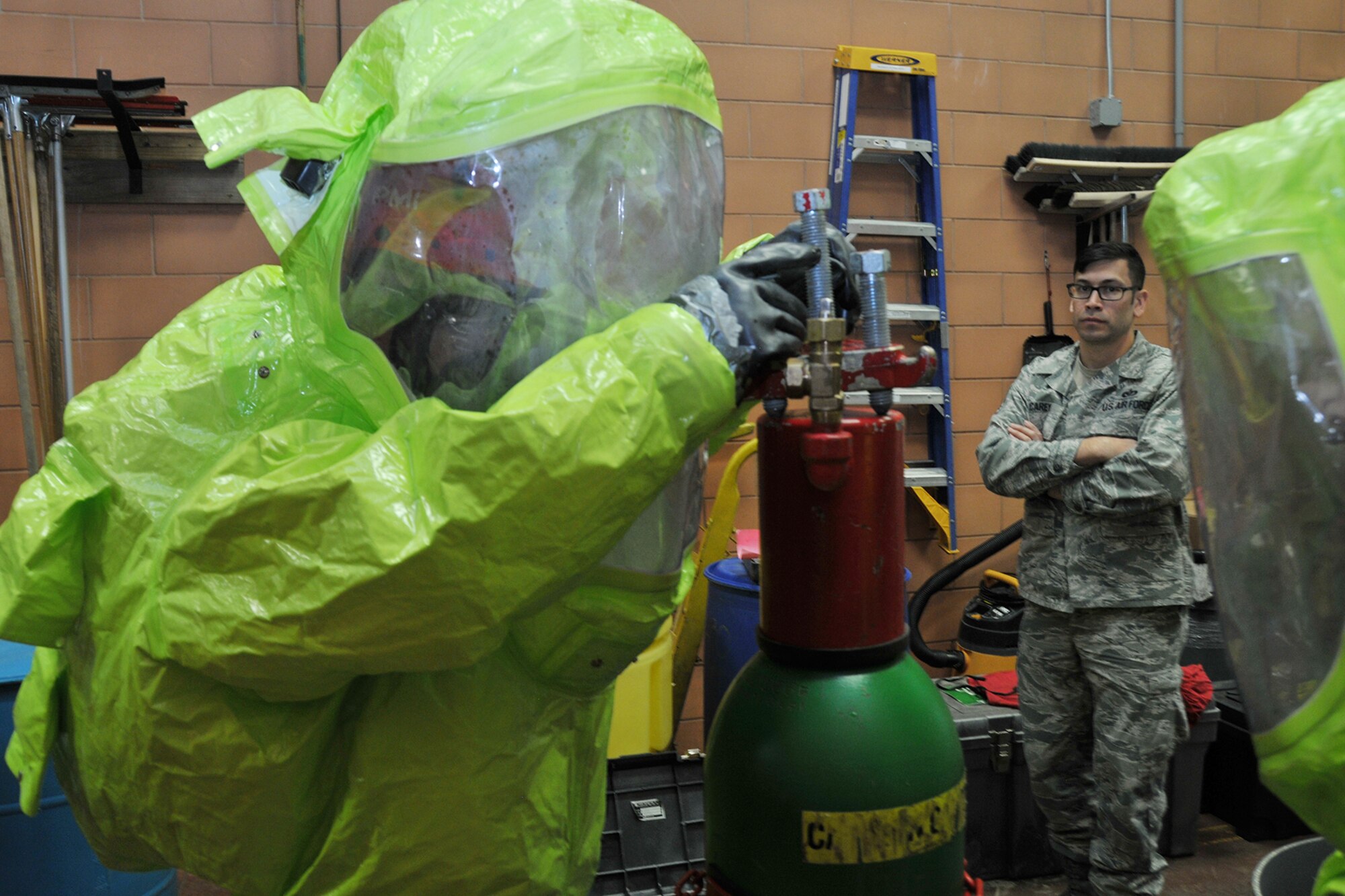 Staff Sgt. Scott Carey, a firefighter with the 910th Civil Engineer Squadron (CES), evaluates 910th CES Firefighter Tech. Sgt. Owen Brownfield here, Dec. 4, 2016, as he completes his Hazardous Materials (HAZMAT) training. The training is required for firefighters and enables them to safely and proficiently deal with any hazardous materials they may encounter while performing their duties. (U.S. Air Force photo/Staff. Sgt. Rachel Kocin) 