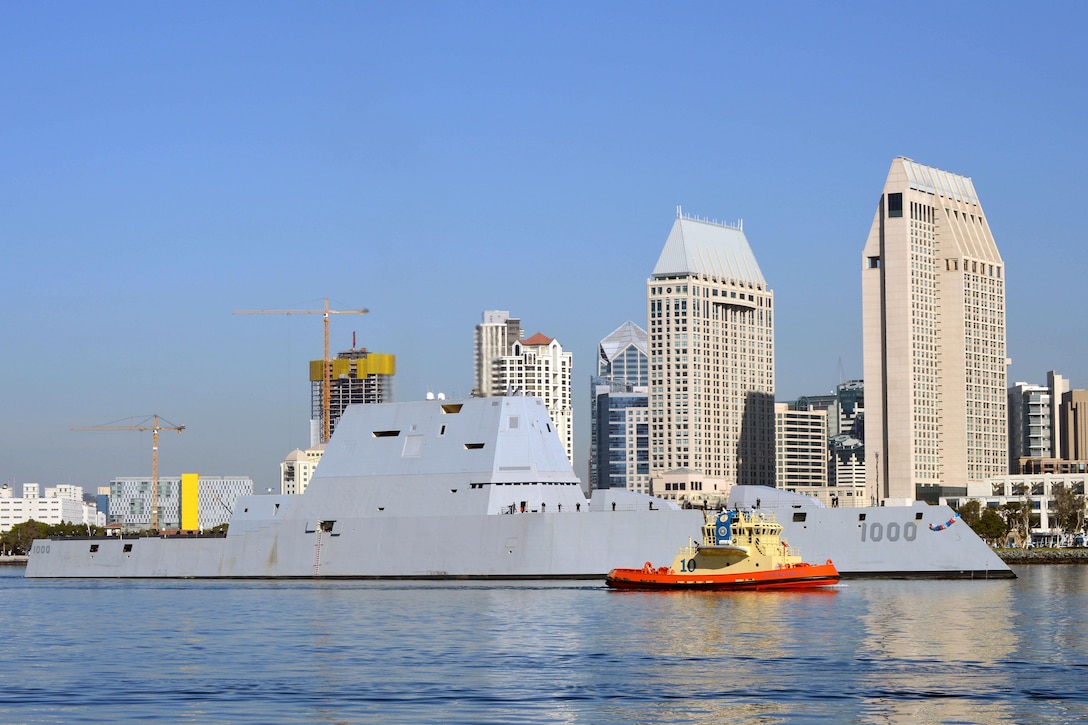 A tugboat escorts the USS Zumwalt through San Diego Bay as the ship nears the end of the journey to its new home port in San Diego, Dec. 8, 2016. Navy photo by Petty Officer First Class Trevor Welsh