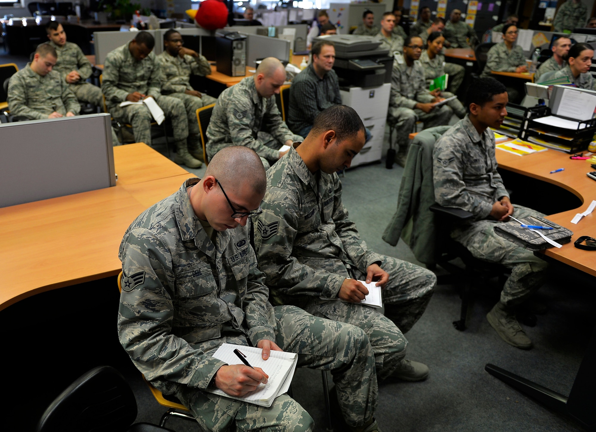 Airmen assigned to the 86th Comptroller Squadron take notes during a talk delivered by Chief Master Sgt. Kaleth Wright, U.S. Air Forces in Europe and Air Forces Africa command chief, at Ramstein Air Base, Germany, Nov. 23, 2016. The future 18th Chief Master Sgt. of the Air Force discussed topics with Airmen ranging from leadership, mentorship, and developments in the Air Force. (U.S. Air Force photo by Airman 1st Class Joshua Magbanua)