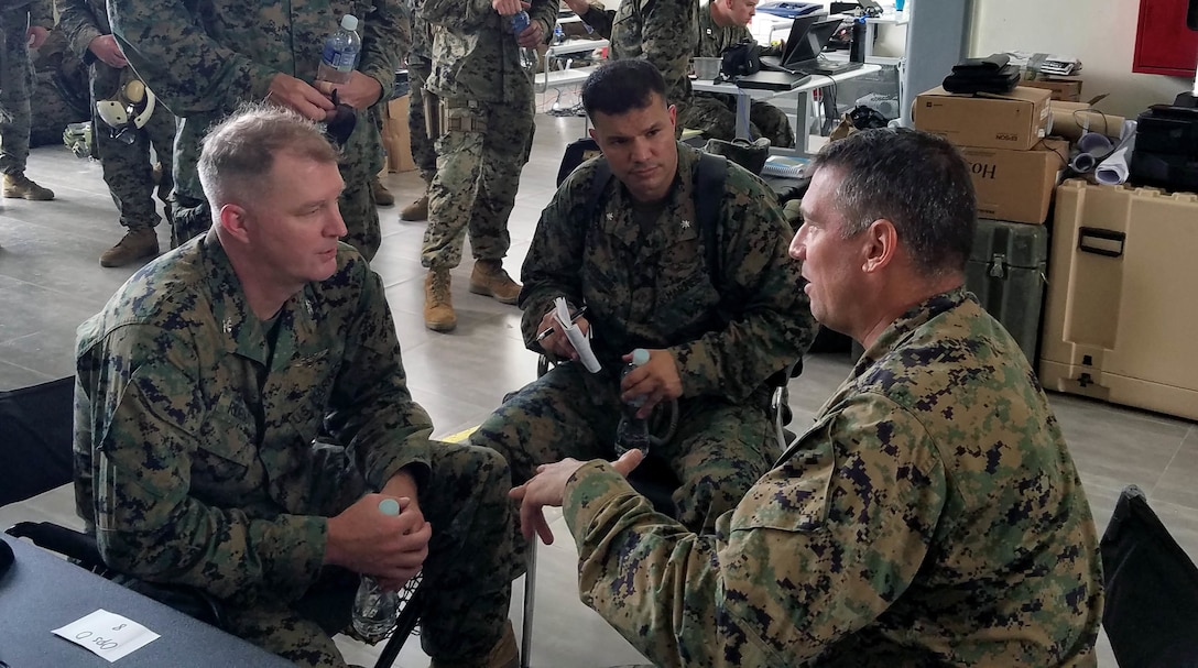 Marine Col. Thomas Prentice, commanding officer of Special Purpose Marine Air-Ground Task Force Southern Command, speaks with Col. Ryan S. Rideout, commanding officer of the 24th Marine Expeditionary Unit about ongoing relief operations in Haiti. - Photo by Staff Sgt. Robert Durham