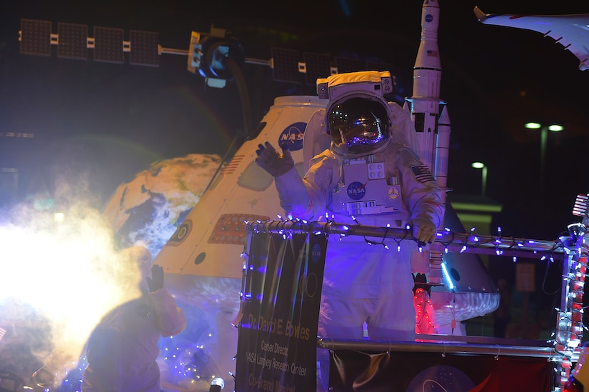 A member of NASA Langley Research Center waves during the Holly Days Parade in Hampton, Va., Dec. 10, 2016. NASA Langley will celebrate their 100 years in 2017, following Joint Base Langley-Eustis, who celebrated theirs during 2016. (U.S. Air Force photo by Senior Airman Kimberly Nagle)