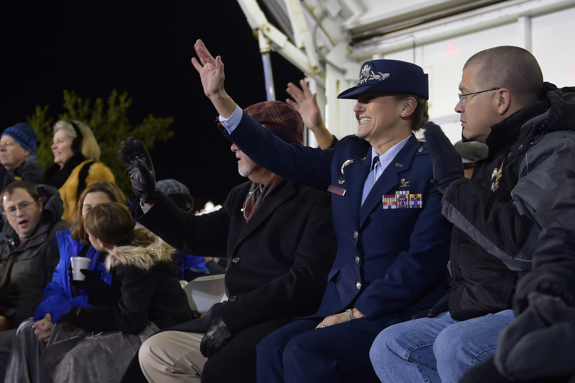 U.S. Air Force Col. Caroline M. Miller, 633rd Air Base Wing commander, waves as floats pass by during the Holly Days Parade in Hampton, Va., Dec. 10, 2016. After a short time riding on the float made by Joint Base Langley-Eustis, Va., members, Miller viewed the parade as the Grand Marshall. (U.S. Air Force photo by Senior Airman Kimberly Nagle) 