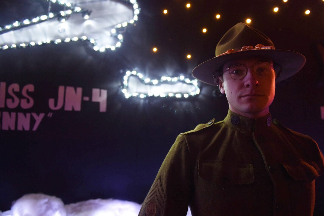 U.S. Air Force Senior Airman Andrew Gaca, 633rd Civil Engineer Squadron power pro technician, poses in front of the Joint Base Langley-Eustis, Holly Days Parade float in Hampton, Va., Dec. 10, 2016. Volunteers from JBLE dressed up in uniforms representing the last 100 years of service highlighting 100 Years of Langley. (U.S. Air Force photo by Senior Airman Kimberly Nagle) 