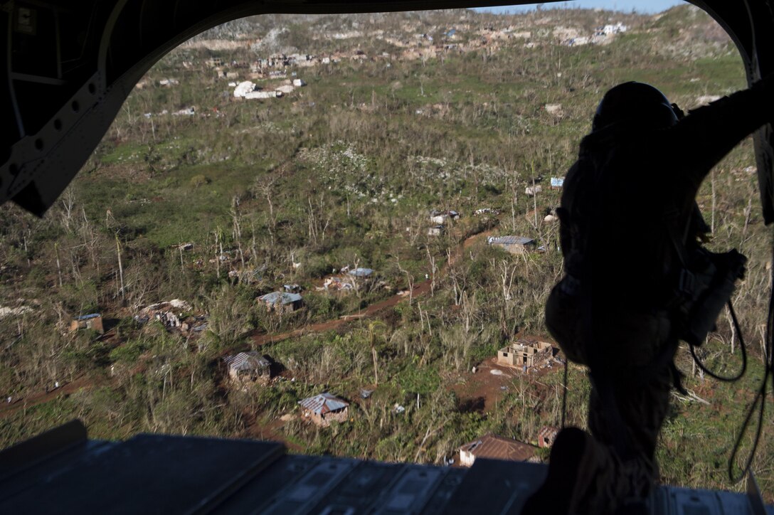 U.S. Army Staff Sgt. Derrick Auten, with 1st Battalion, 228th Aviation Regiment, looks for the landing zone near Beaumont, Haiti, Oct. 13, 2016. Auten is assigned to 1st Battalion, 228th Aviation Regiment, which is providing airlift of supplies to areas of Haiti affected by Hurricane Matthew. (U.S. Air Force Photo by Tech. Sgt. Russ Scalf)