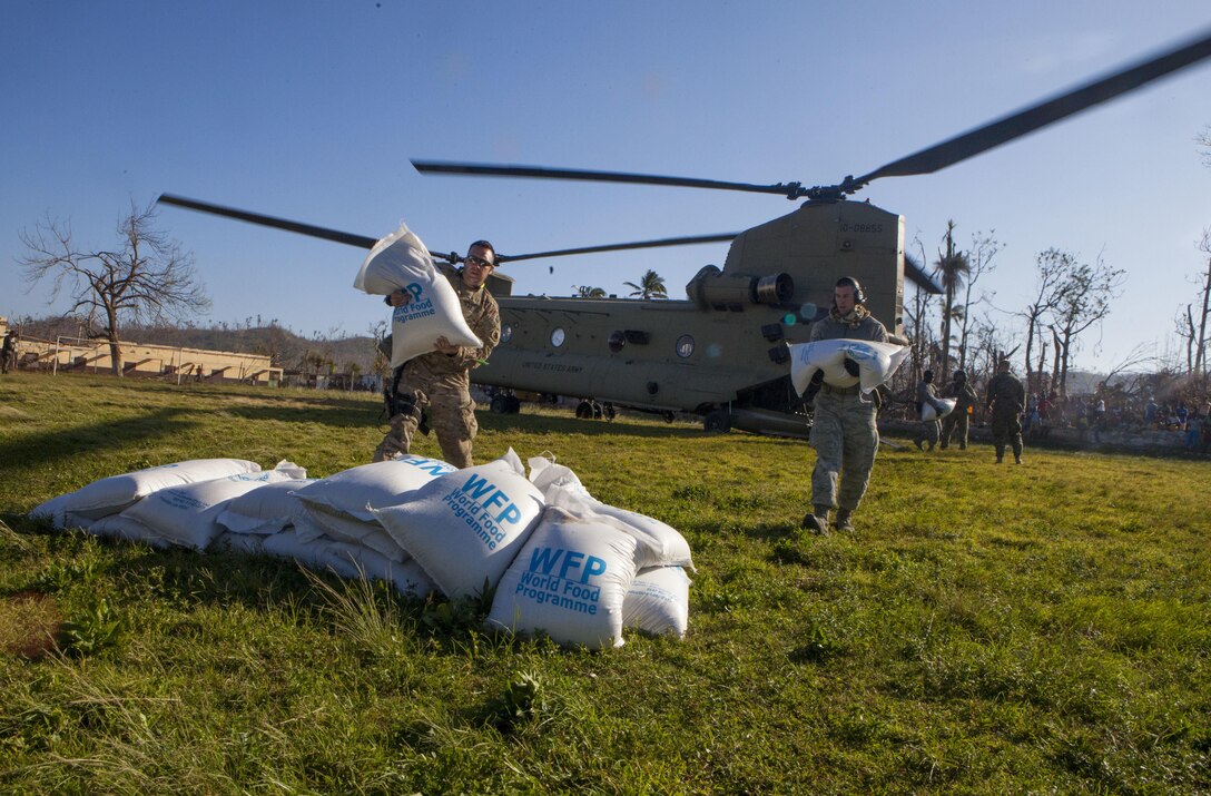 Service members from Joint Task Force Matthew stack bags of rice in Dame Marie, Haiti during a supply drop to the areas affected by Hurricane Matthew October 12, 2016. After five days of supply drop operations; JTF Matthew has delivered over 116 metric tons of supplies utilizing CH-53E Super Stallion and CH-47 Chinook helicopters. JTF Matthew, a U.S. Southern Command-directed team, is comprised of Marines, soldiers, sailors and airmen deployed to Port-au-Prince at the request of the Government of Haiti on a mission to provide humanitarian and disaster relief assistance in the aftermath of Hurricane Matthew. (U.S. Marine Corps photo by Sgt. Adwin Esters/Released)