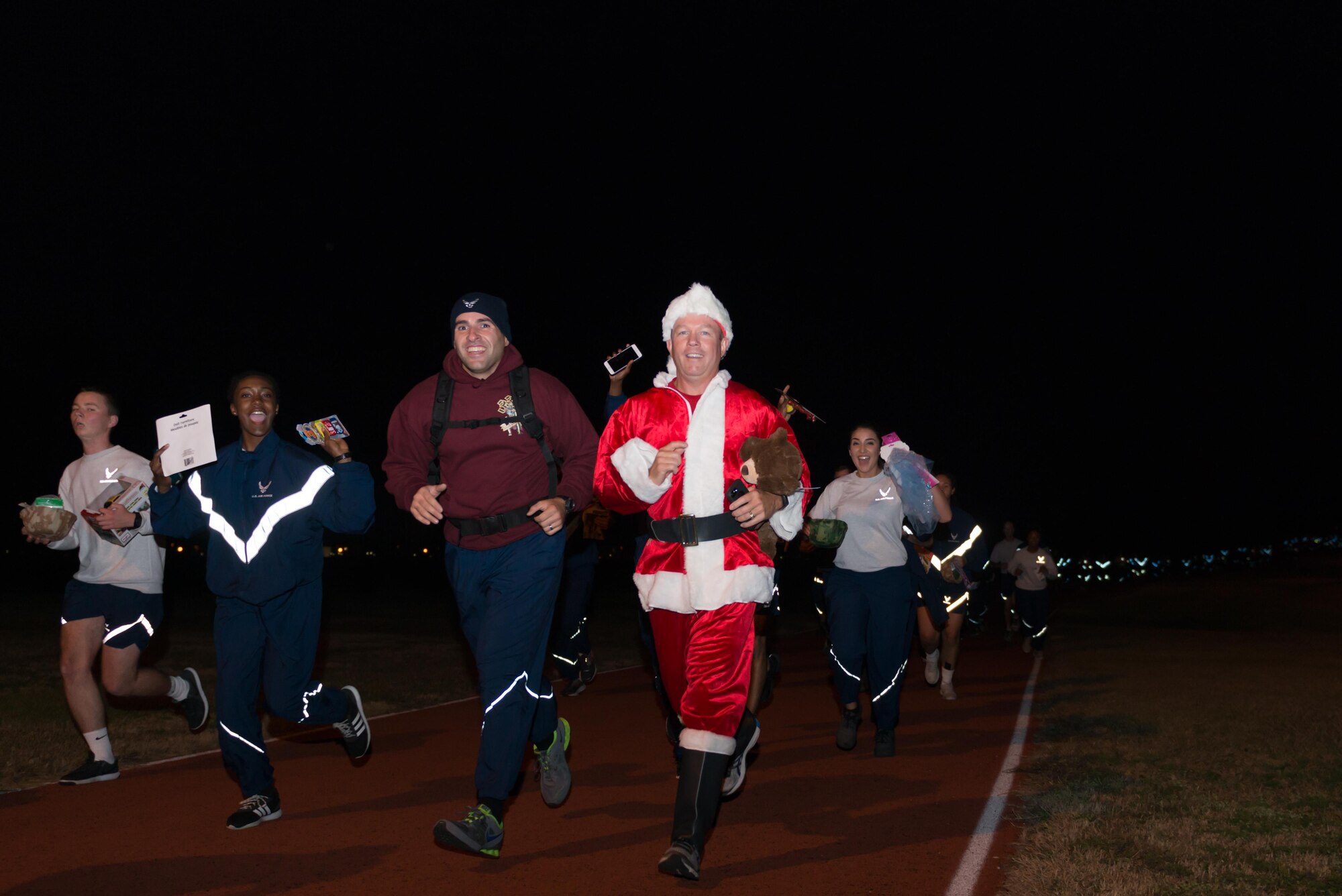 Col. Scott Solomon, 81st Training Group commander runs with non-prior service Airmen during the 5K “Toys for Tots” run, Dec. 11, 2016, on Keesler Air Force Base, Miss. The run began at the Levitow Training Support Facility and ended in the Bayridge housing area. Each of the runners donated a toy at the finish line to support the U.S. Marine Corps Reserve Toys for Tots Program.  (U.S. Air Force Photo by Andre’ Askew)