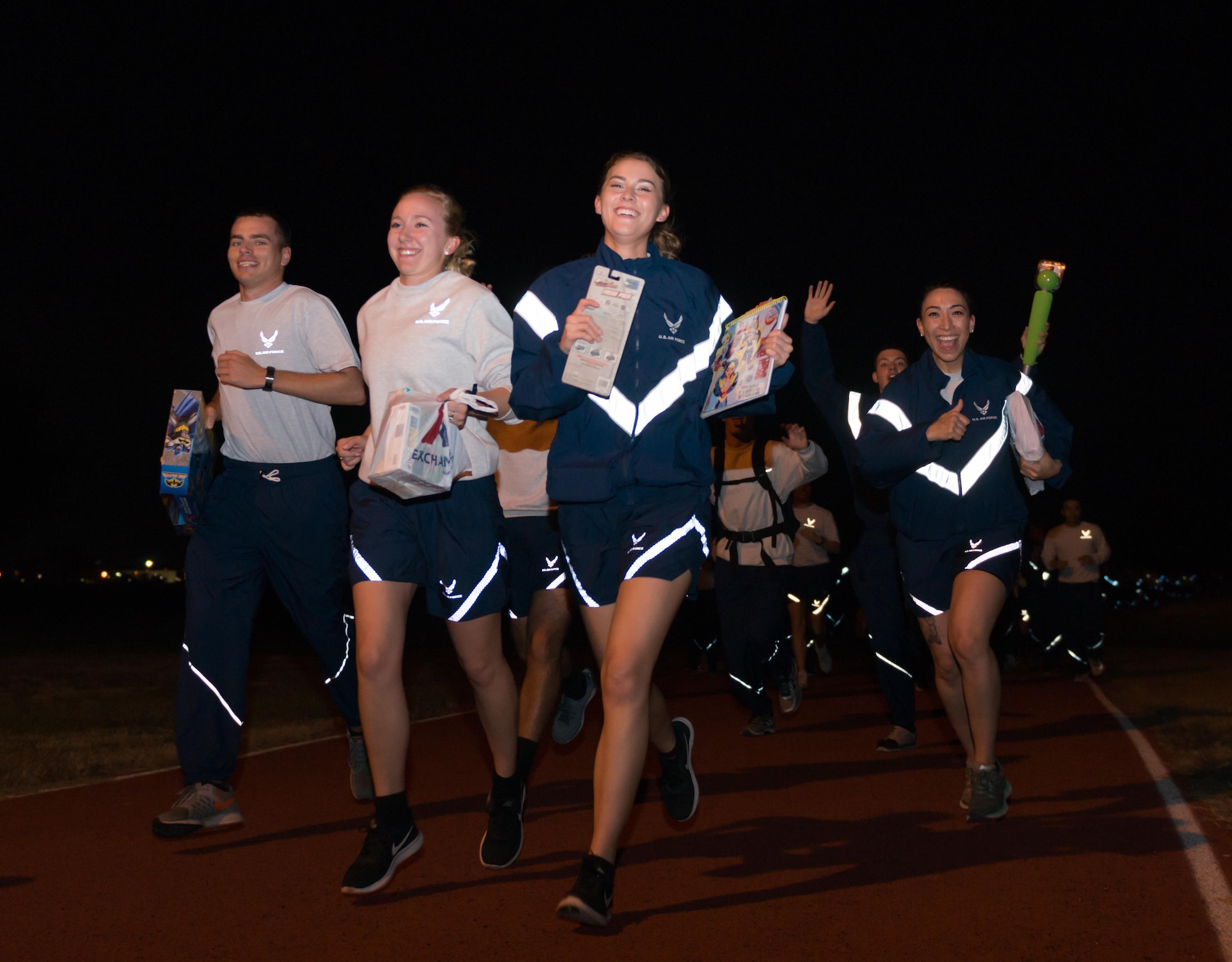 Non-prior service Airmen from the 81st Training Group run with a gift to  donate during the 5K “Toys for Tots” run, Dec. 11, 2016, on Keesler Air Force Base, Miss. The 5K run was in support of the U.S. Marine Corps Reserve Toys for Tots Program, which collects and distributes toys in the community. Each participant donated a toy at the finish line.  (U.S. Air Force Photo by Andre’ Askew)