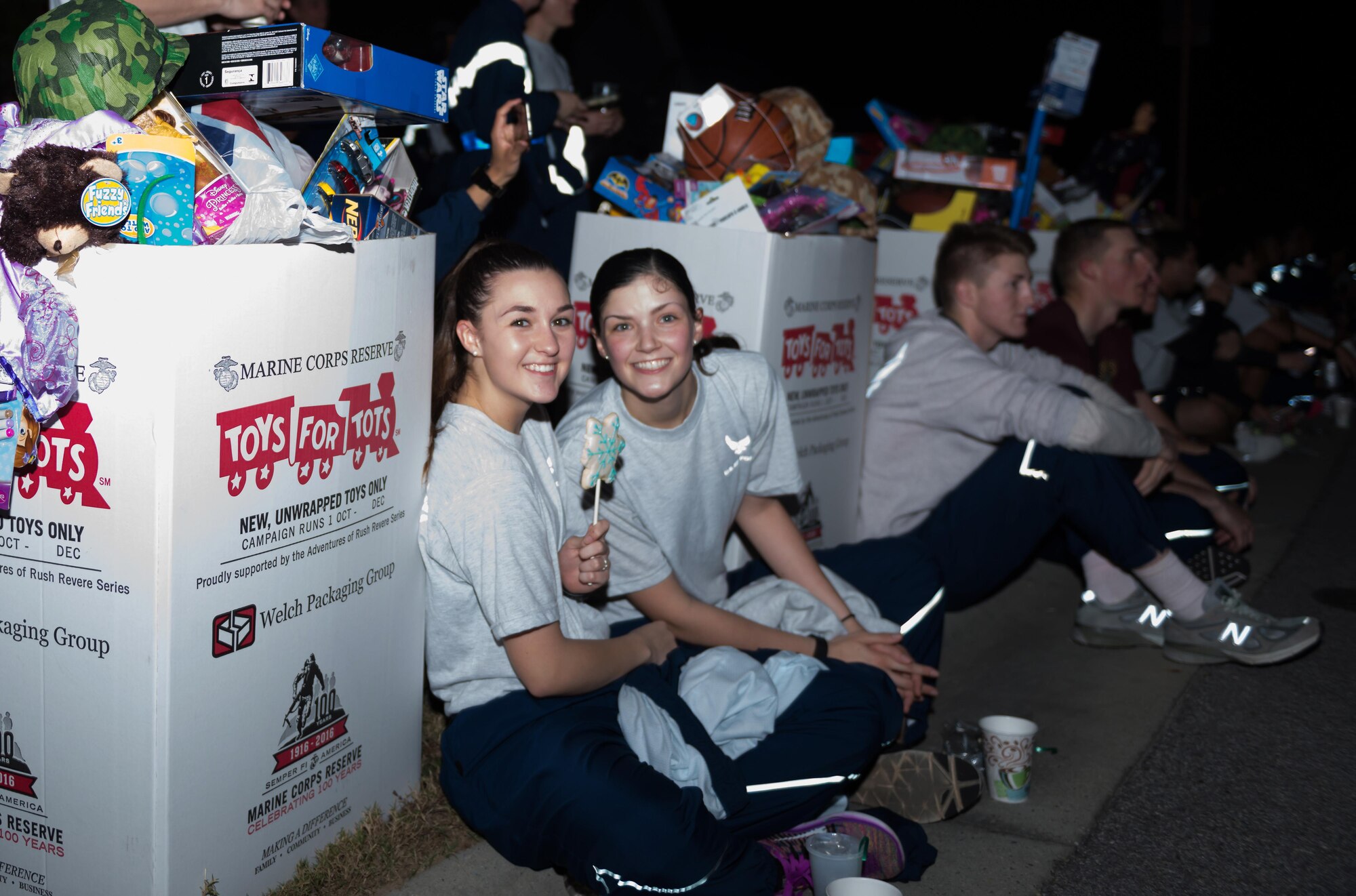 Airman 1st Class Kaitlynn Heckman and Airman Jean Fourqurean, 335th Training Squadron students, relax after completing a5k run, Dec. 11, 2016, on Keesler Air Force Base, Miss. The 5K run was in support of the U.S. Marine Corps Reserve Toys for Tots Program, which collects and distributes toys in the community. Each participant donated a toy at the finish line.  (U.S. Air Force Photo by Andre’ Askew)